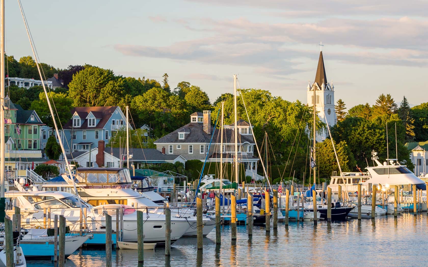 A harbor with many boats and houses.