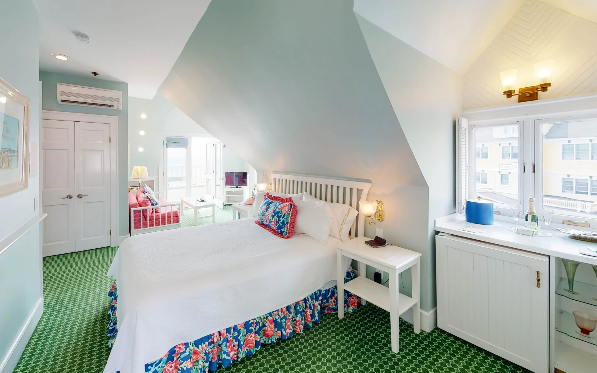 White bed in a blue room with lighting.