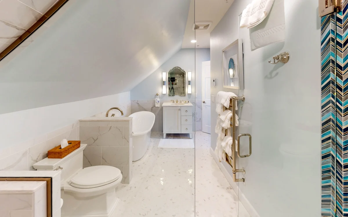 A white bathroom with a shower in the