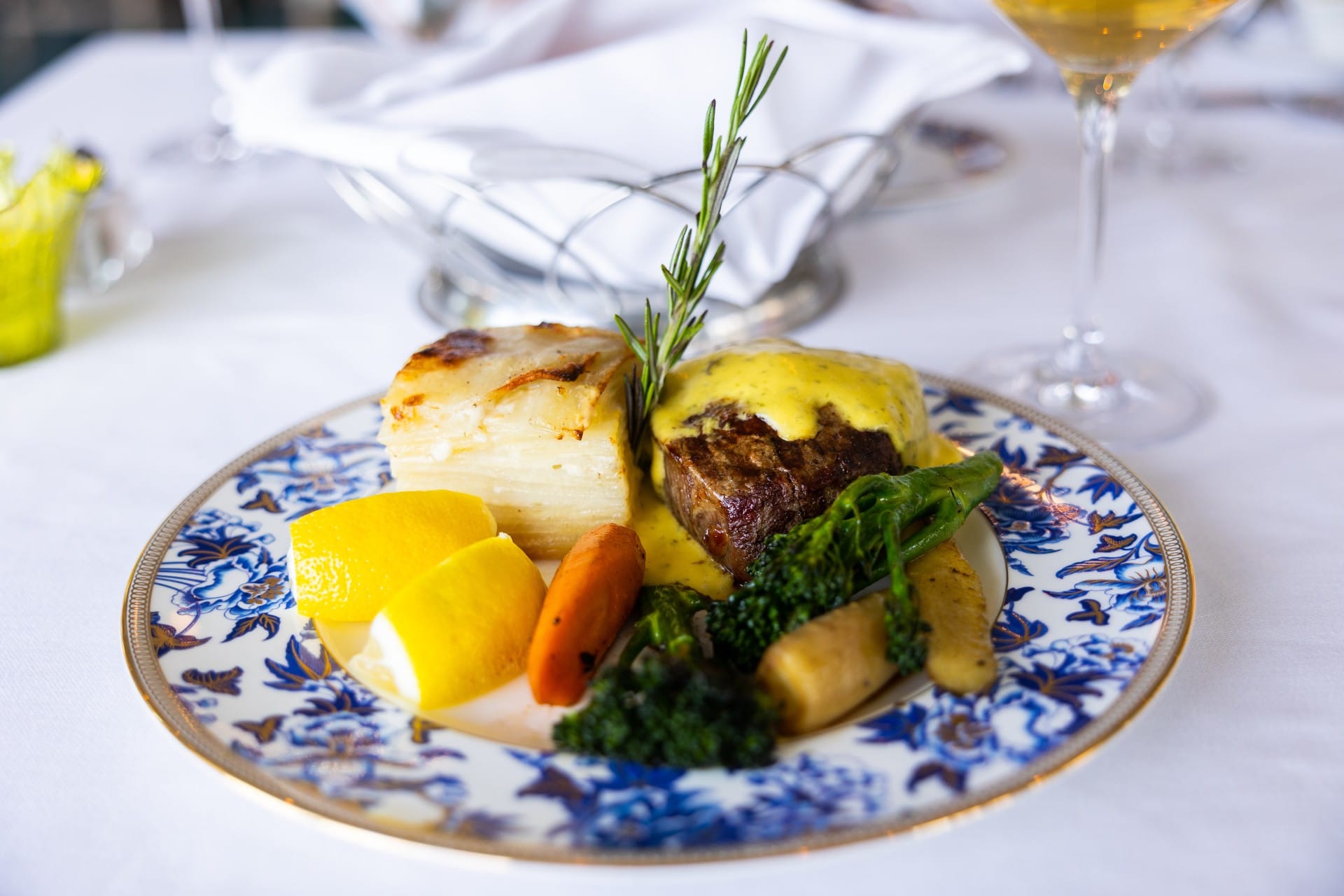 A fancy meal with potato, carrot, boccalini, chicken, and rosemary.
