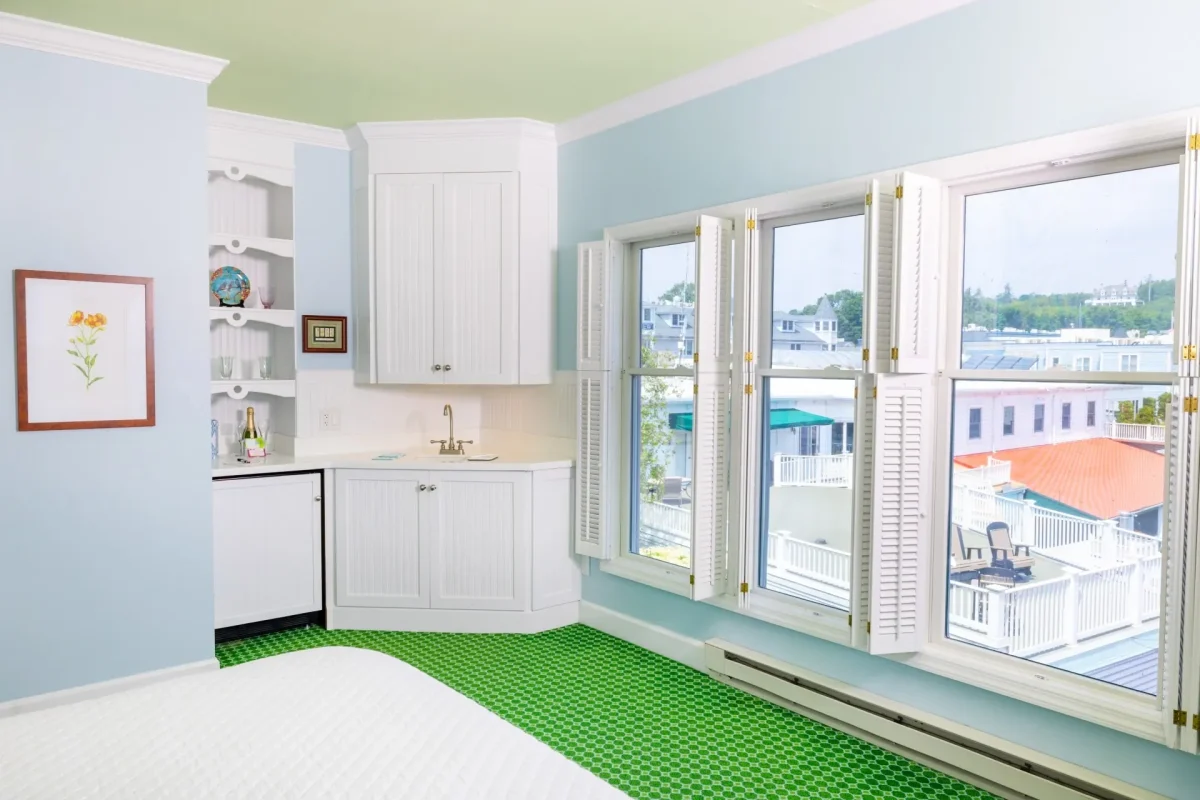 Kitchenette and windows that look out onto a lake.