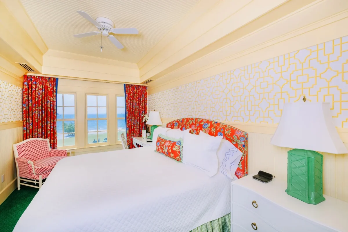 a cream-colored room with white bed.