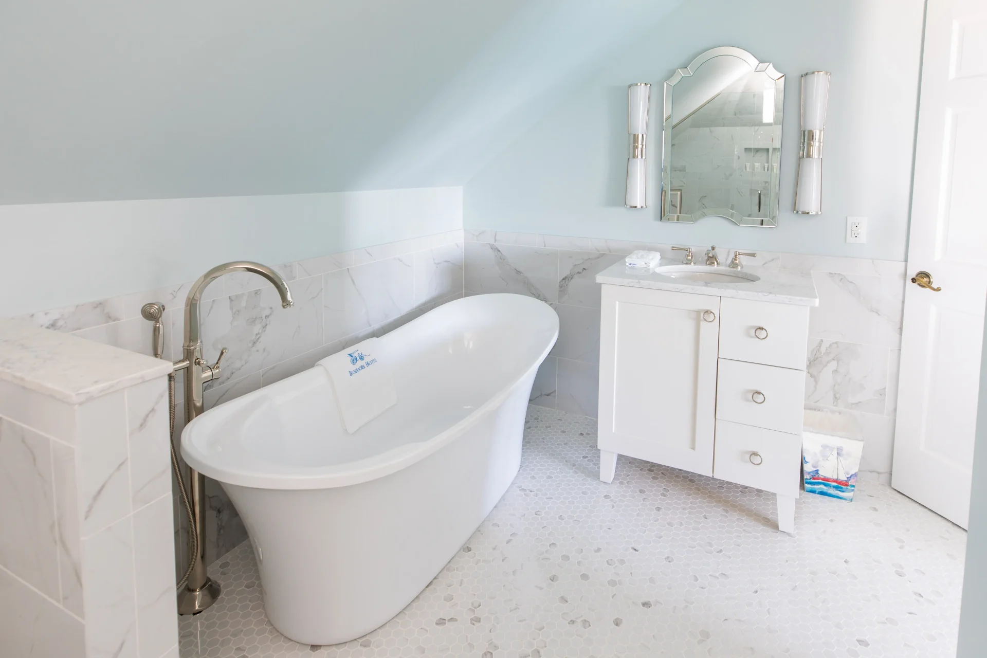 A white tiled bathroom with side fill bathtub.