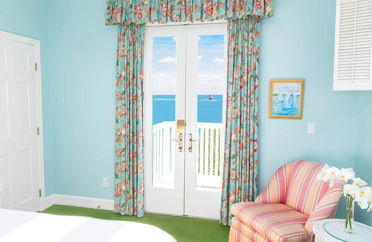 A blue room with view of a patio looking out onto Lake Superior.
