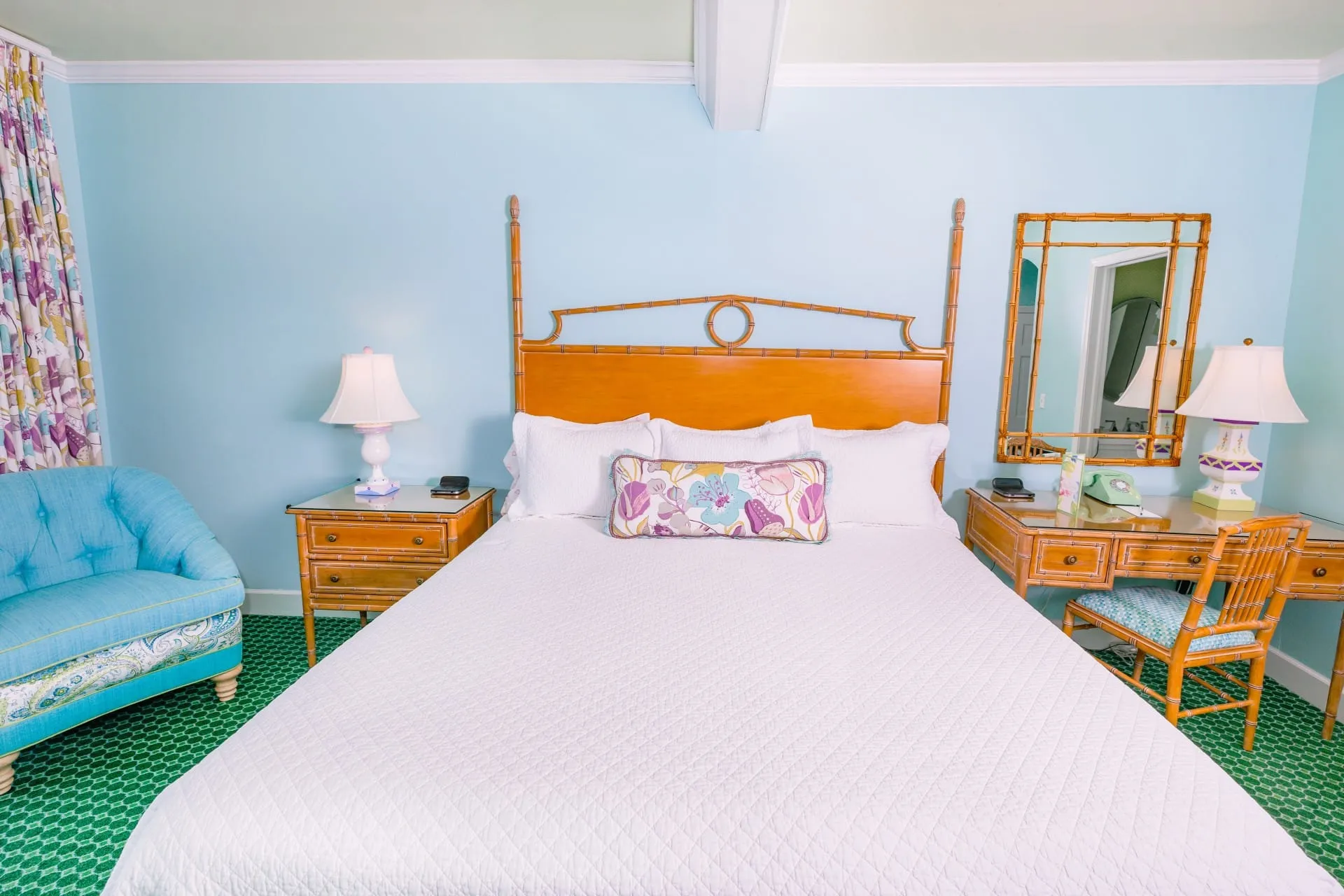 A white bed and a blue room with lighting.